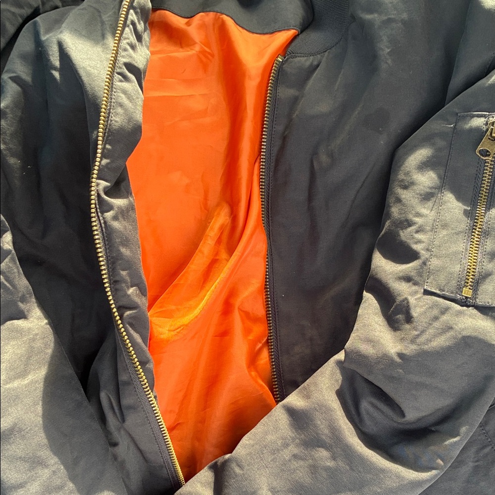 Classic Black Bomber Jacket with Vibrant Orange Lining